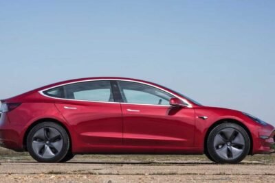 1640891920 tesla model 3 red side view