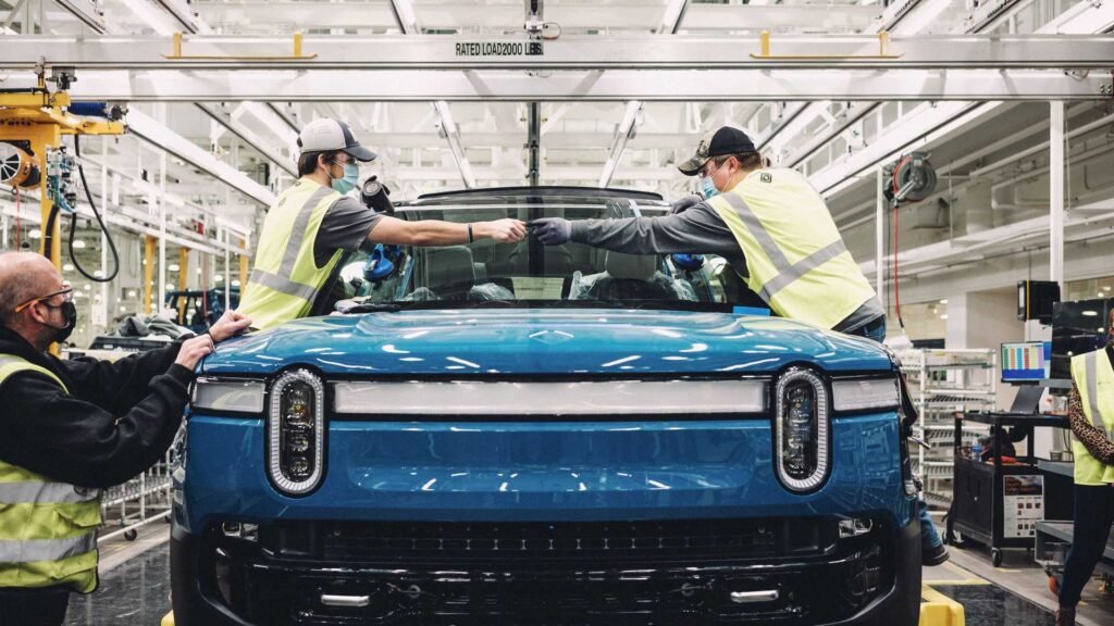 assembly team members inserting a windshield on a rivian r1t on the validation production line at rivian s manufacturing plant in normal il