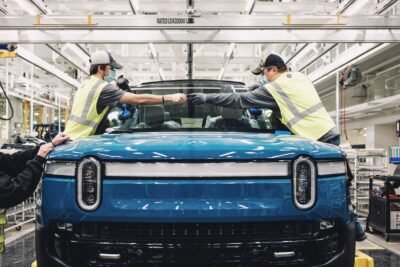 assembly team members inserting a windshield on a rivian r1t on the validation production line at rivian s manufacturing plant in normal il