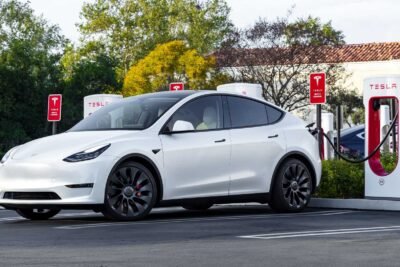 tesla model y charging at a tesla supercharging station